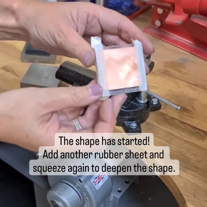 Image shows that the shape has started. Add another piece of rubber sheet and squeeze in the vise again.